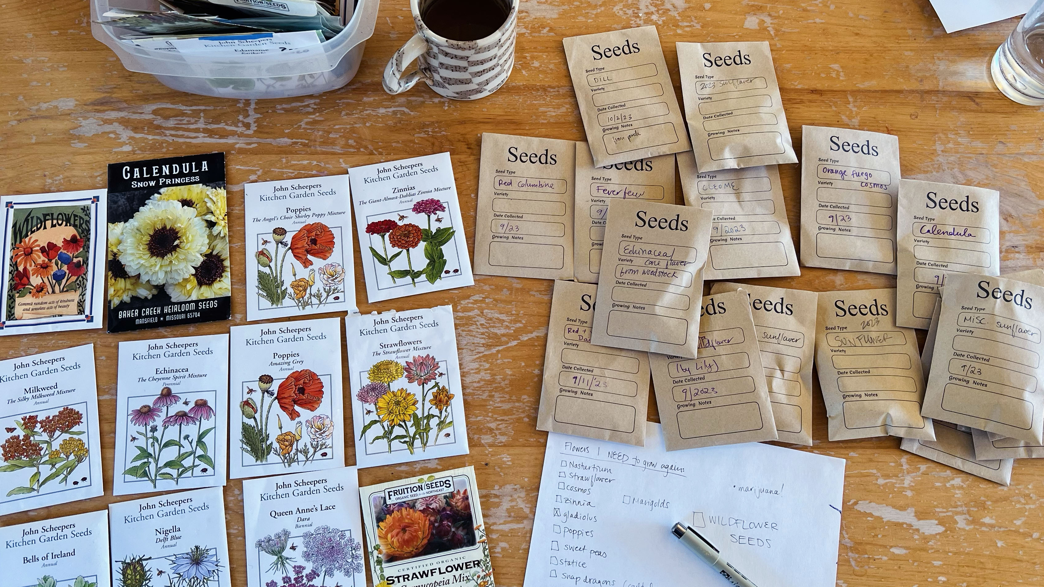 Seed packets and a notebook on a dining table